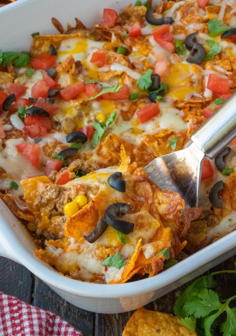 Dorito Casserole with a spatula scooping some out.